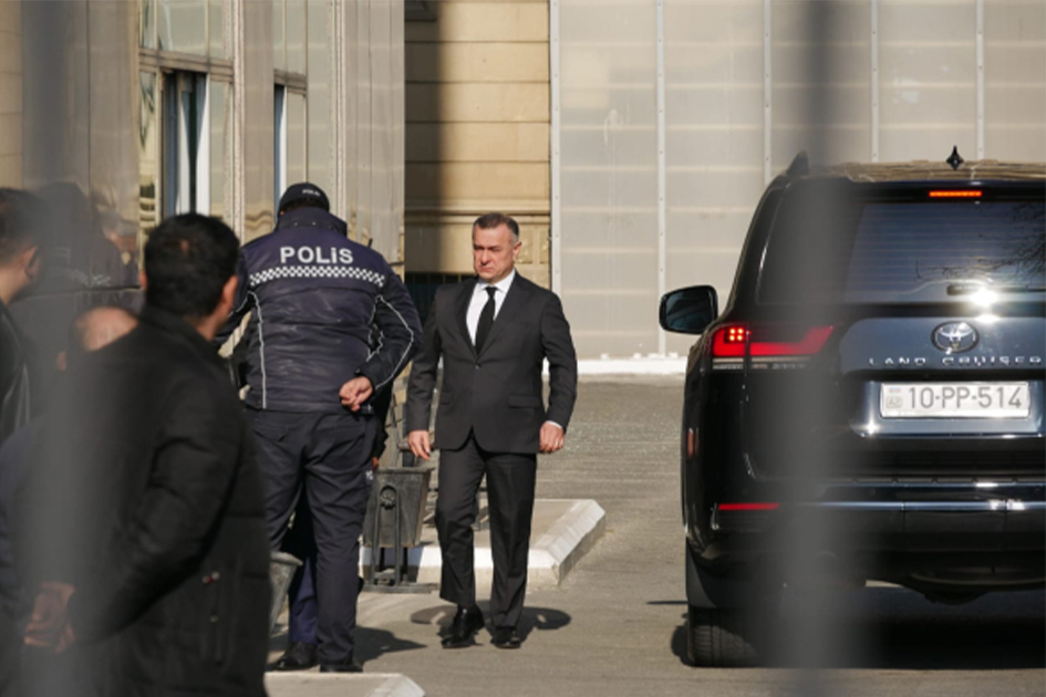 a man in a suit walking with a group of people