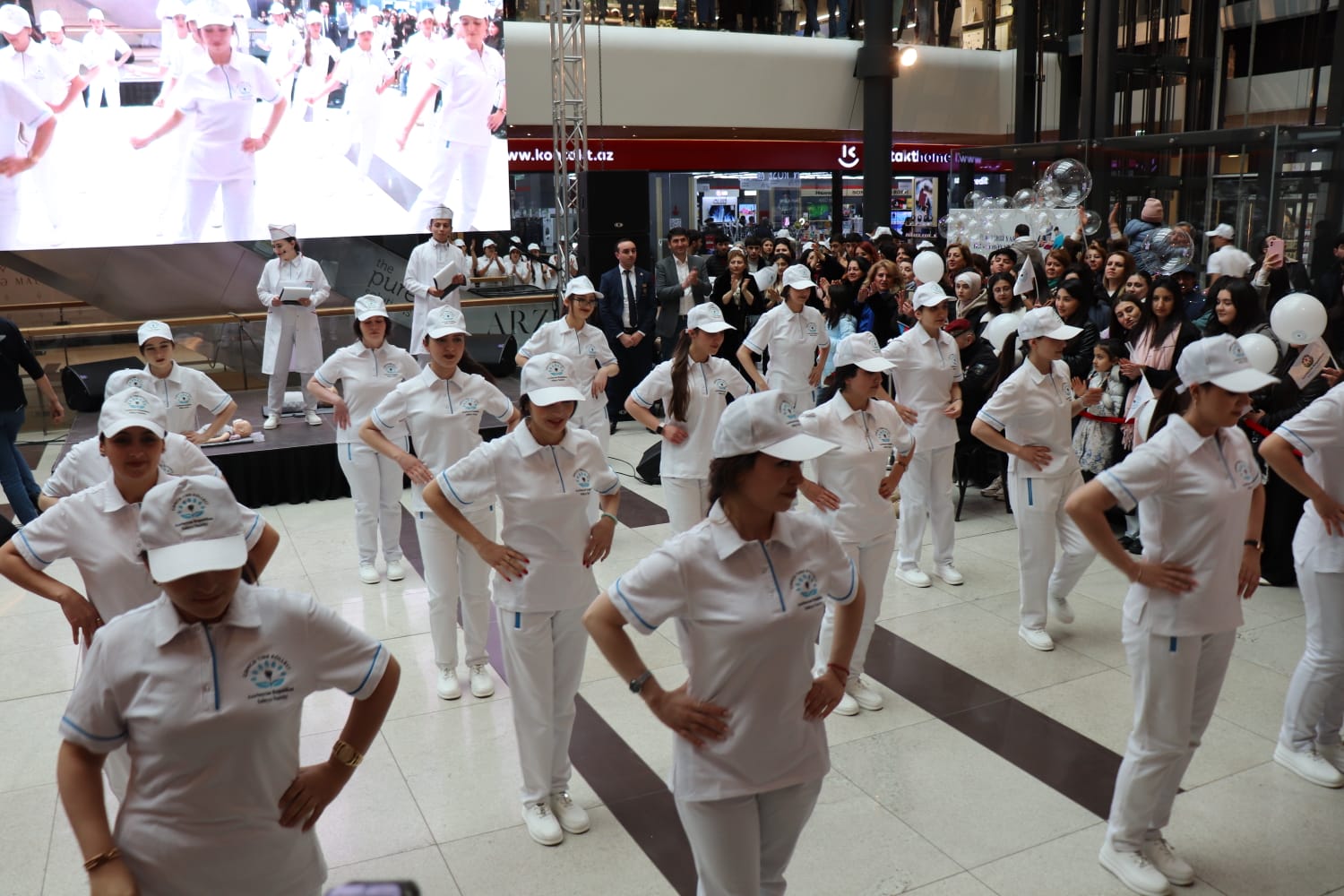 a group of people wearing white caps and gowns