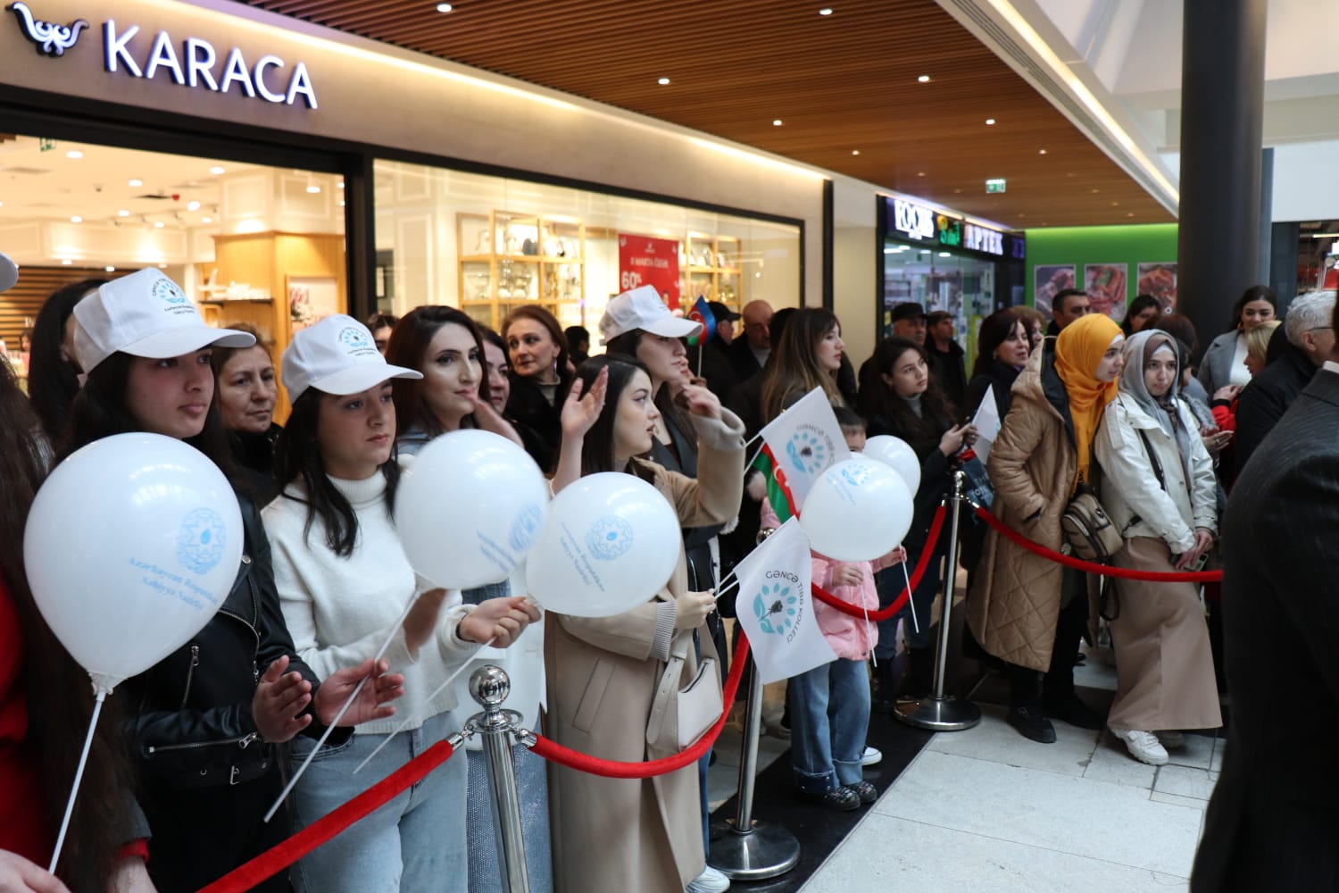 a group of people wearing white hats and holding white balloons