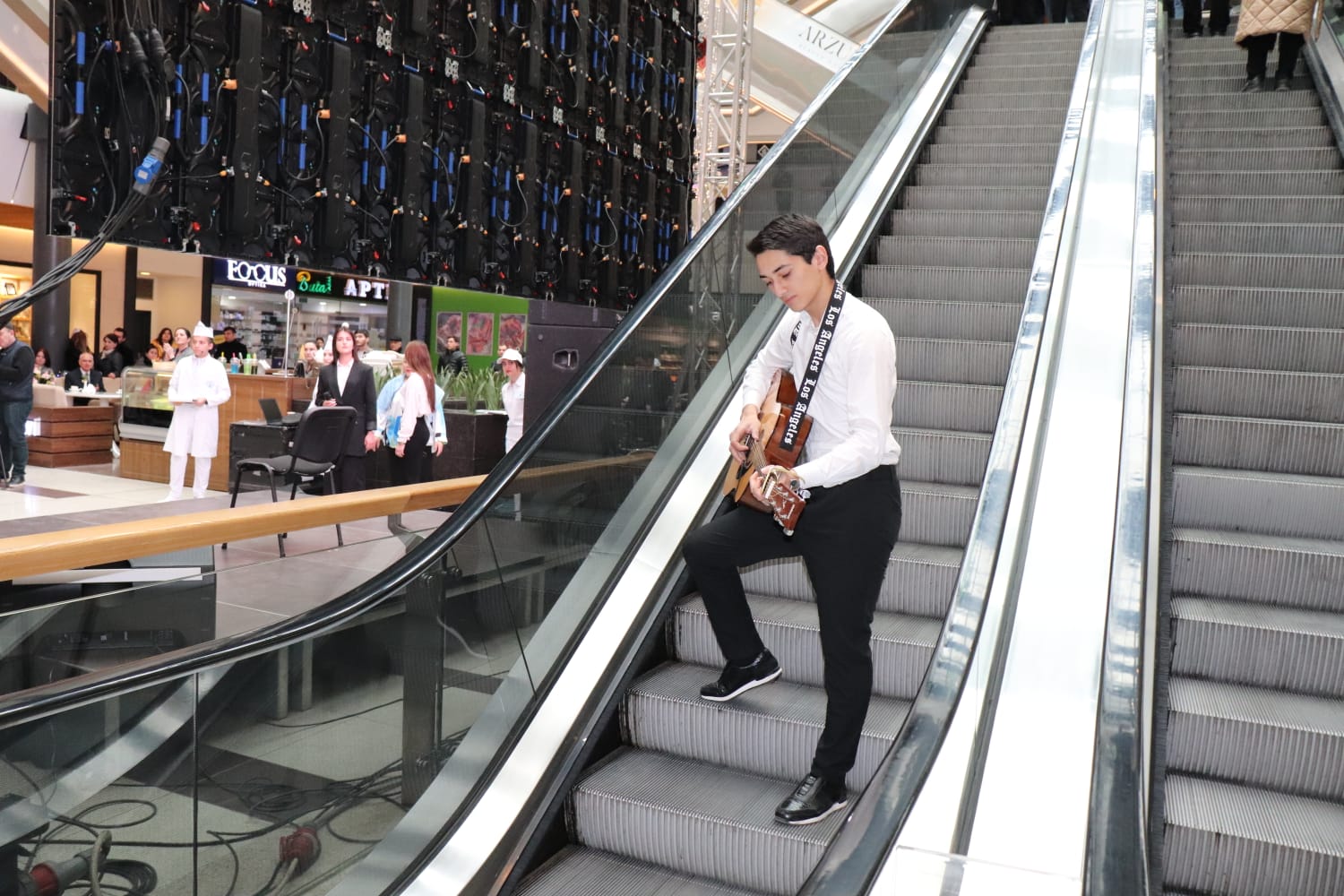 a person standing on a escalator