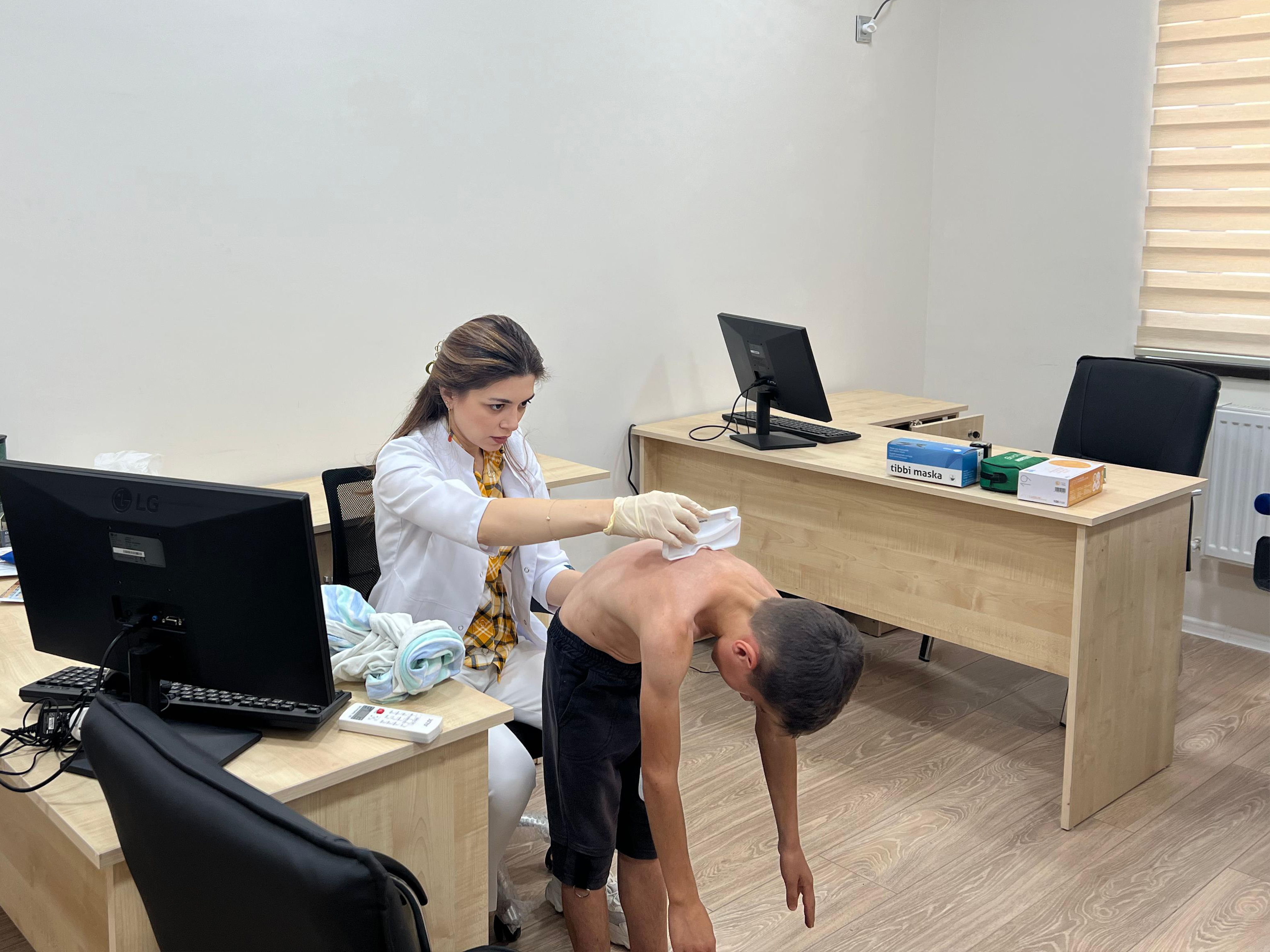 a person washing a person's head in a room