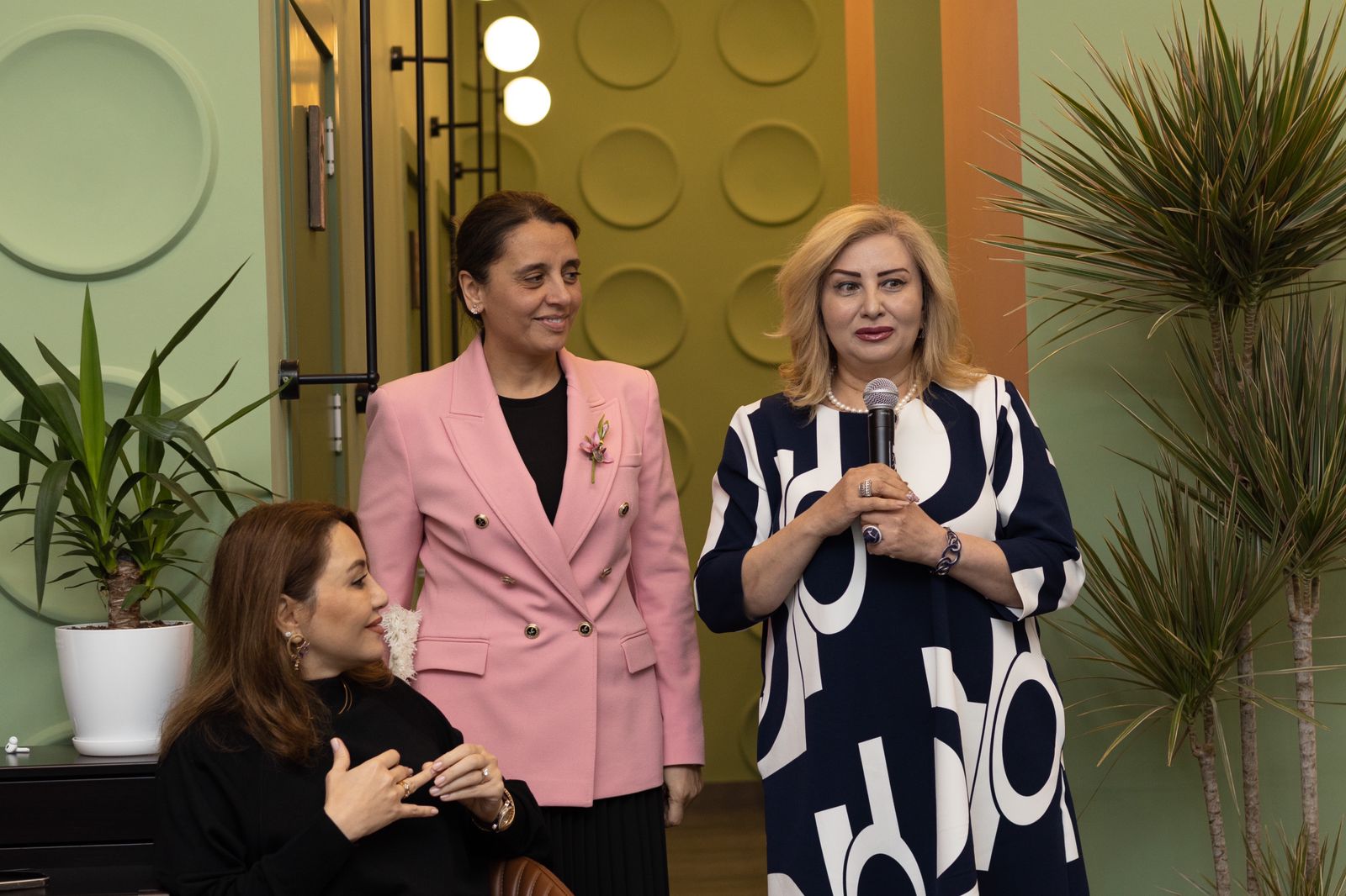 a group of women standing and talking