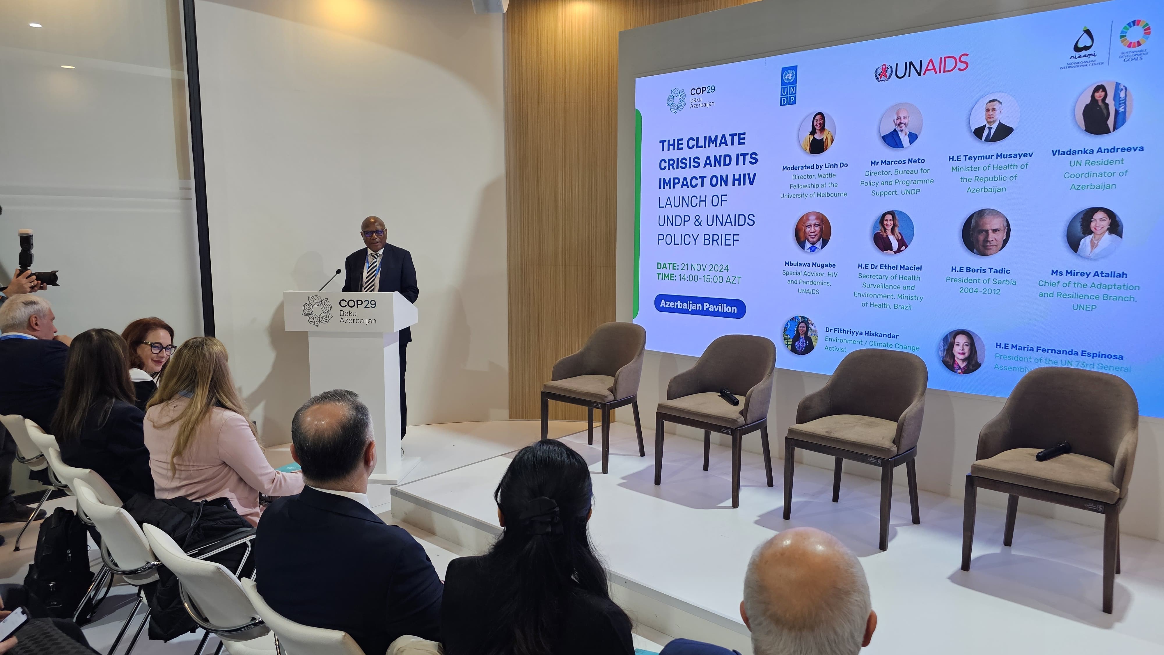 A speaker addresses an audience at COP29 in Baku, Azerbaijan, discussing the climate crisis and its impact on HIV.