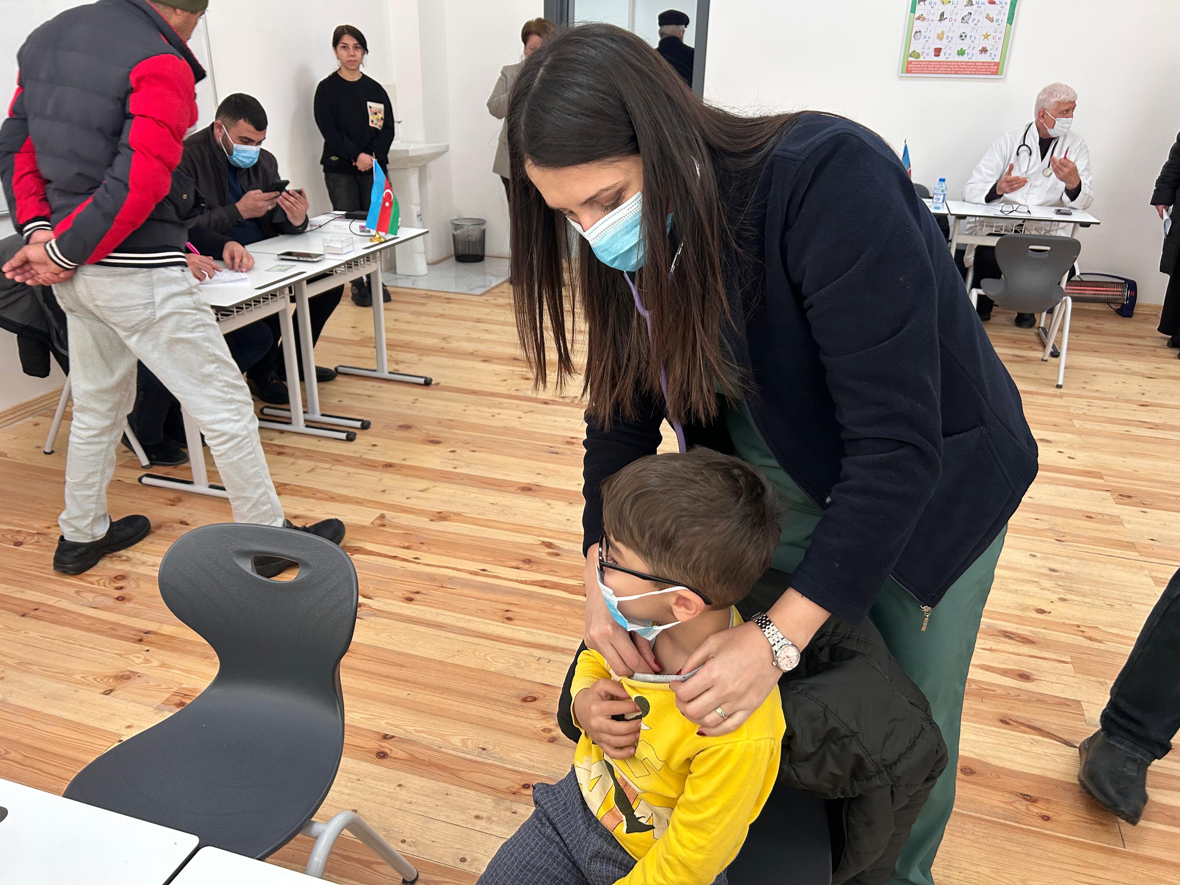 a person helping a child with a toy