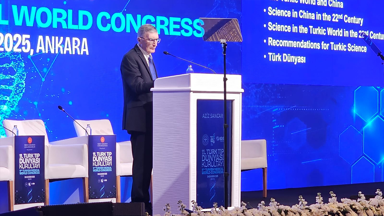 A speaker presents at the 11th Turkic Medical World Congress in Ankara, 2025, with a digital backdrop displaying topics on science.